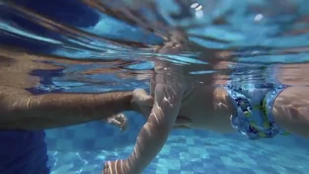 Mutlu gülümseyerek yürümeye başlayan çocuk babası ile su altında dalış — Stok video