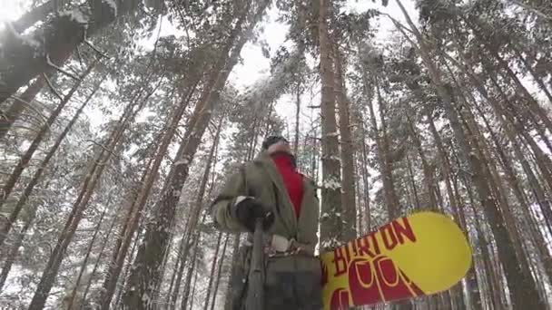 Caminante snowboarder aventura a través del bosque con snowboard — Vídeos de Stock