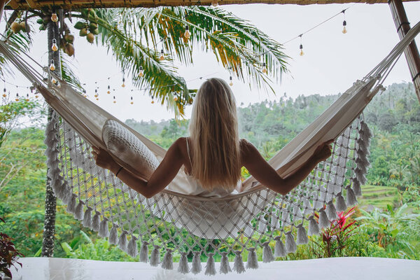 Healthy sleep in the open air at hammock. Sexy woman relaxing