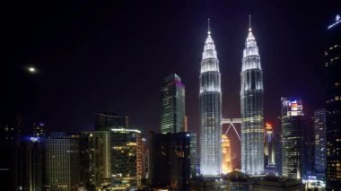 Kuala Lumpur, Malezya - 27 Haziran 2020: Kuala Lumpur şehir merkezinde ay batarken gece sahnesi. Eğil.