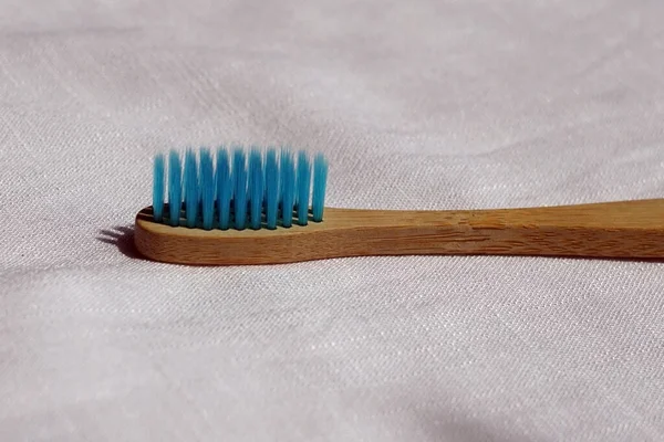 Close Eco Friendly Blue Bamboo Toothbrush White Linen Background Natural — Stock Photo, Image