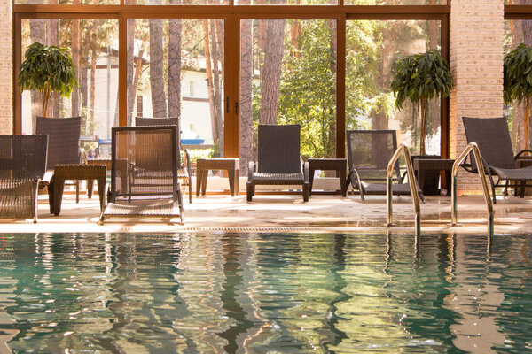 Empty pool, chaise lounges. Indoor swimming pool