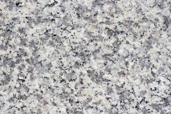 Granite texture with black and gray splashes. Polished granite background.