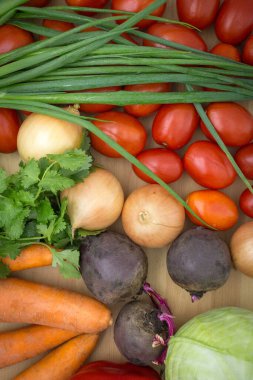 Tahta atölyede taze sebzeler, yakın plan: pancar, yeşil soğan, kişniş, domates, soğan, havuç. Sağlıklı yemek, vejetaryen yemeği. Borş çorbası ürünleri..