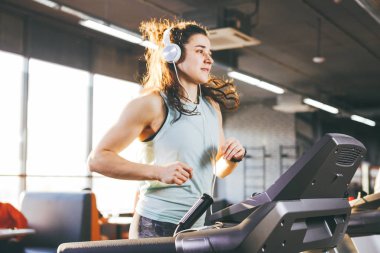 Spor ve müzik temasıdır. Güzel bir şişirilmiş kadın spor salonunda bir koşu bandı üzerinde çalışır. Kafasında büyük beyaz kulaklık, kilo kaybı için bir kardiyo egzersiz sırasında kız müzik dinliyor.