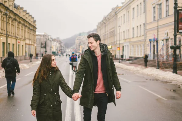 young couple, heterosexual boy and girl of Caucasian nationality, loving couple, walk around the center of country of European city in the middle of road on divided lane. Love and Romance Theme.