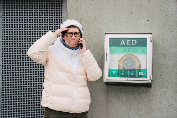 medicine cardiopulmonary resuscitation emergency call. Caucasian woman uses telephone calling 911 help. device box aed automatic defibrillator diseases, clinical death, cardiac arrest and heart attack