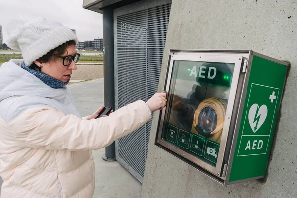 medicine cardiopulmonary resuscitation emergency call. Caucasian woman uses telephone calling 911 help. device box aed automatic defibrillator diseases, clinical death, cardiac arrest and heart attack