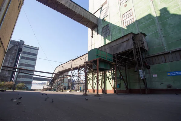 El territorio de la antigua planta. Edificios para almacenamiento y transporte de alimentos. Las estructuras metálicas de la torre y las torres en la obsoleta planta de Europa del Este, el impacto sobre los contaminantes ambientales — Foto de Stock