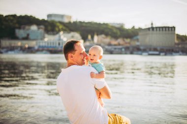Konu rekreasyon baba ve küçük oğlu. Genç beyaz baba, Kiev kasabasına bakan ve Dinyeper nehrini tutan ahşap bankta oturur, bankalar daki kumlu plajda yeni yürümeye başlayan bir bebeğe sarılır.