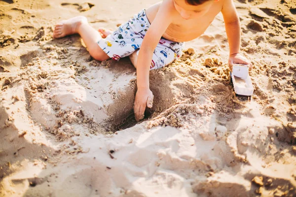 Kinder spielen am Strand. Sand und Wasser Spielzeug. LKW-Spielzeugauto mit Sand und Erde. grüne Umwelt Baumaschinen bei der Arbeit, Baukonzept. Industriesymbole. — Stockfoto