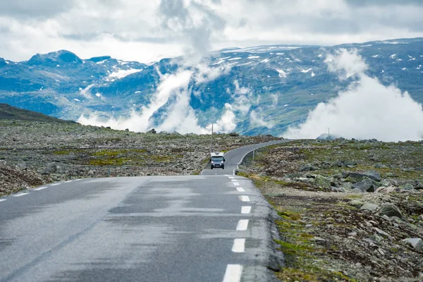 Mașină de rulare în munții norvegieni. Vacanță turistică și călătorii. Mașina de rulotă RV călătorește pe drumul montan, trece Norvegia. Scandinavia Europa. Ruta turistică națională norvegiană — Fotografie de stoc gratuită