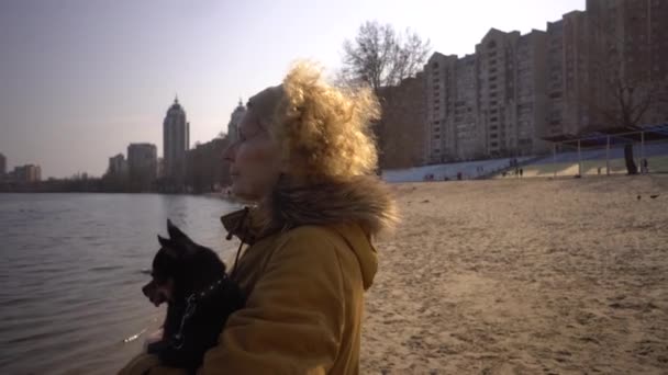 Portrait Of An Adult Blonde Curly Hair Caucasian Woman Holding A