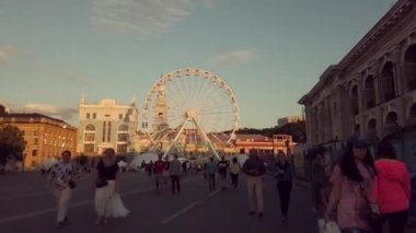 Ukrayna Dinamik timelapse video Dönme Dolap, Kiev Temmuz 6, 2019. Sözleşme alanında hafta sonu tatilleri. İnsanlar Avrupa'nın merkezindeki meydanın etrafında dolaşıyorlar. Eski şehir