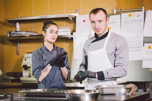 Cheerful Experienced Man And Woman Staff. Profession preparation confectionery products. Caucasian man and woman two employees colleague teamwork pastry chef. Theme cooking chocolates truffle — Stock Photo, Image