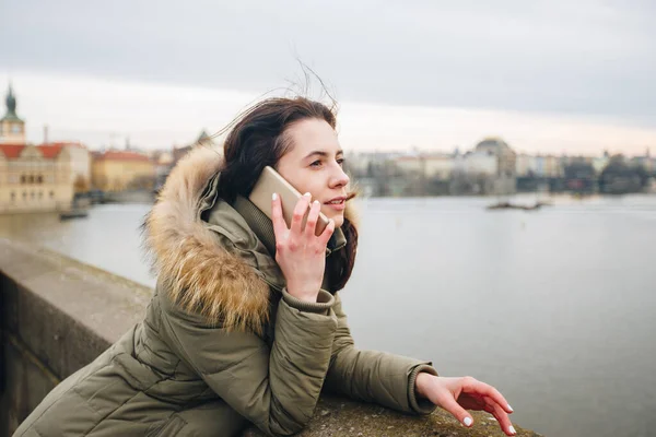 Mulher turista sorridente em Praga falando no smartphone. Jovem turista fica na Ponte Charles em Praga, na República Checa usa telefone — Fotografia de Stock