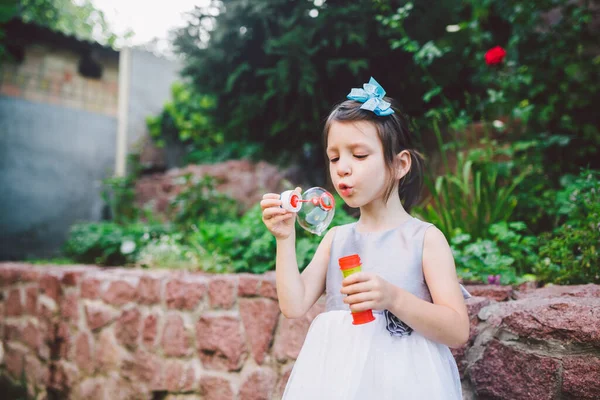Little Caucasian Girl White Dress Plays Soap Bubbles Backyard House — Stock Photo, Image