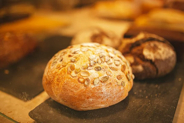 Village bread. Round bread. Bread showcase. Bakery. Homemade baked bakery bread, fresh round bread with pumpkin seeds, with organic wheat flour. Fresh and organic bread oven showcase.