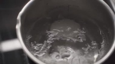 Ev yapımı elektrikli ocakta tencerede kaynamış beyaz yumurtalar. Sıcak suda taze tavuk yumurtası, buhar tenceresi, sağlıklı beslenme, protein yemeği, ev yemeği, kahvaltı ve beslenme konsepti..