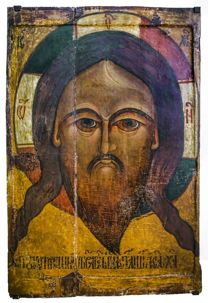 Old Russian Orthodox icon of Christ of the 12th century. Made in the ancient encaustic technique on a wooden frame. Irkutsk, Russia. Isolated on white background.
