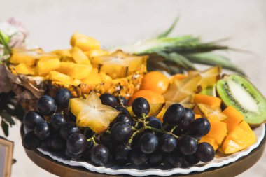 Plajdaki düğün ve ziyafet sırasında kumlu Karayip plajında bulunan süslü masada servis edilen tropikal meyveler. Açık hava etkinlikleri için kumsal yemekleri.