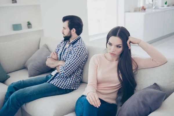Portrait of sad couple having conflict sad man sitting with crossed folded hands ignore his girlfriend after scandal they do not speak with each other having distrust disrespect