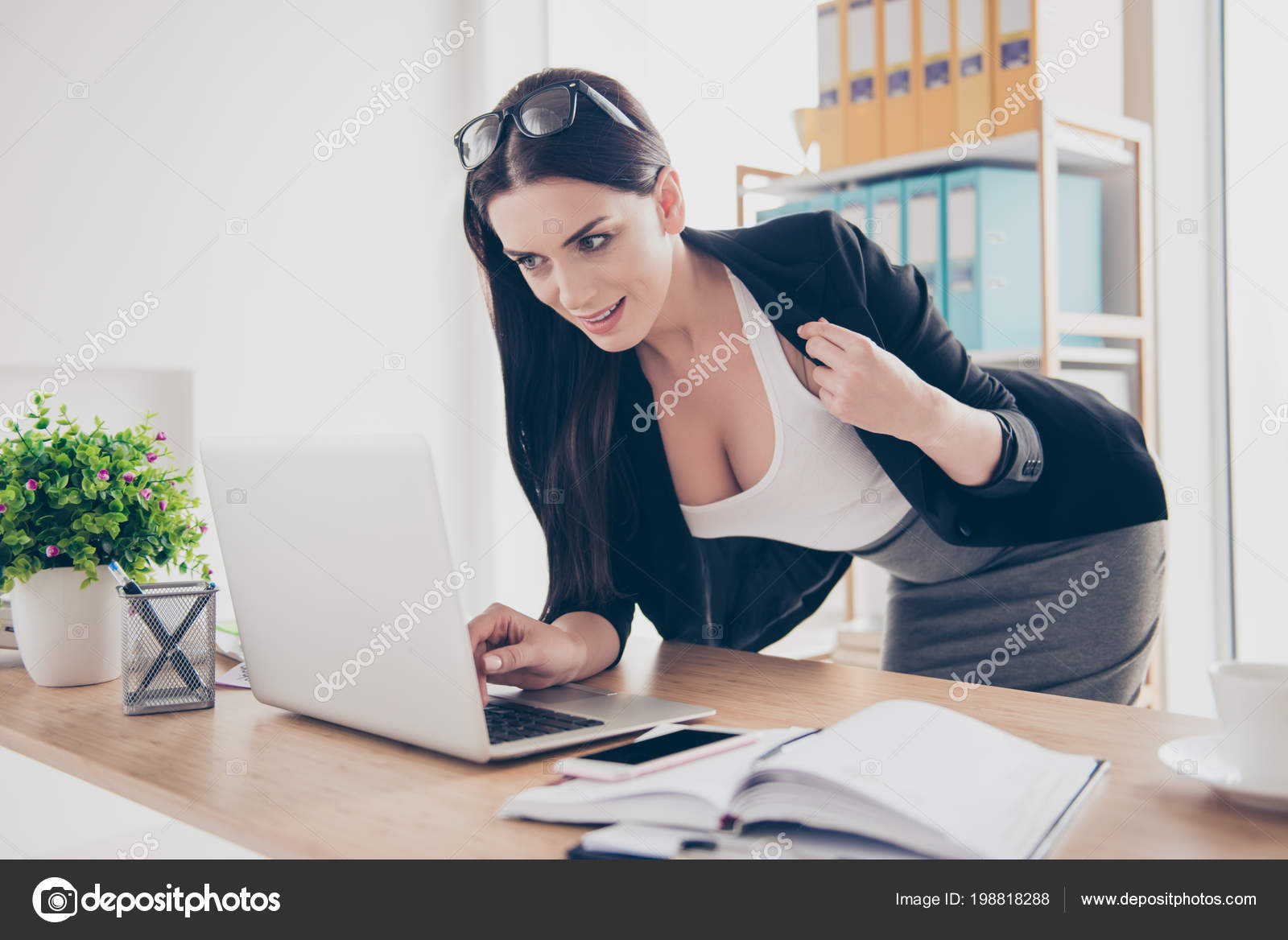 Portrait of charming sexy bending over near desktop showing big tits decollete open jacket having video-call lover — Photo