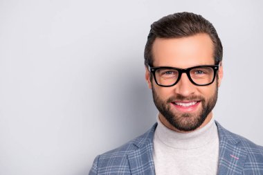 Portrait with copy space of attractive, gentlemen, manly, intelligent, cheerful man with beaming smile, looking at camera over gray background clipart