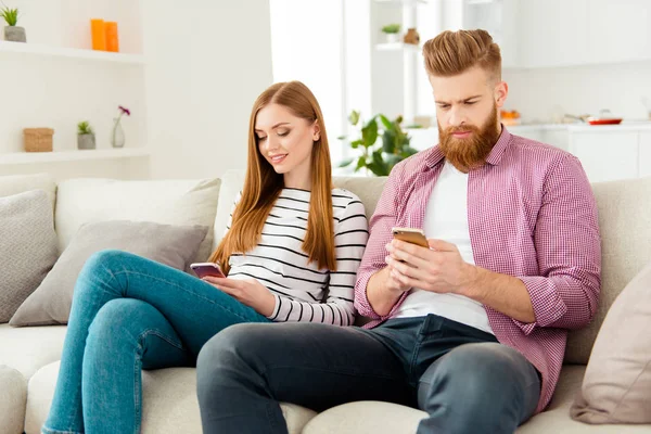 No talking two people partners communication wireless concept. Portrait of handsome serious focused guy and attractive cheerful excited lady using smartphones don't speak with each other