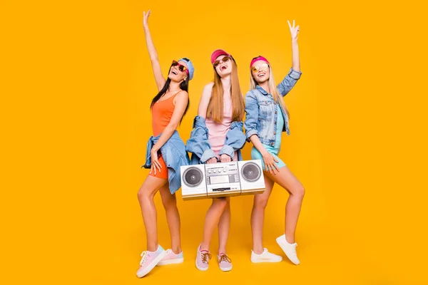 Daydream mood recreation rest relax leisure pleasure summer vibes concept. Portrait of fancy trio with boom box gesturing peace symbol with raised hands isolated on bright yellow background