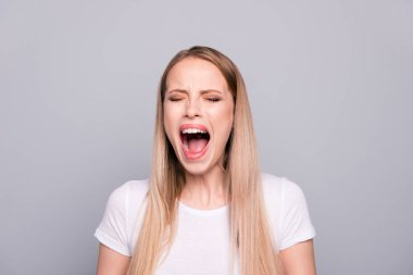 Closeup portrait of angry woman screaming loud close eyes isolated on gray background clipart