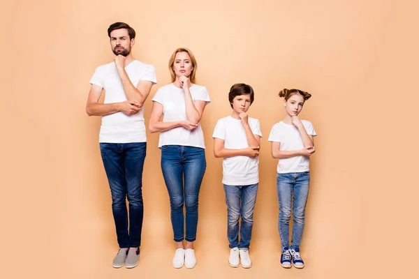 Full length portrait of beautiful family bieng confused, bearded father, blonde mother and their children wearing jeans and T-shirts, standing straight showing uncertain gesture their hands to chins — Stock Image Full Length Portrait Beautiful Family Bieng Confused Bearded Father Blonde Stock Image