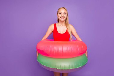 I can't swim! I hope two double safety will help me! Studio photo portrait of cute with beaming toothy smile attractive girl holding green and rosy circles isolated on vivid background clipart