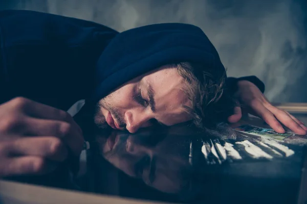 Frustrated exhausted bearded guy in black dark clothing lying on — Stock Photo, Image