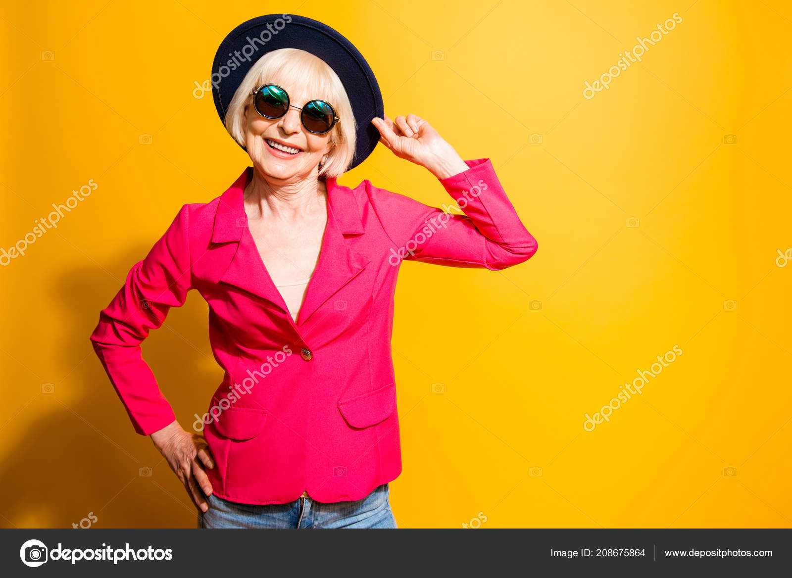 Portrait of charming elderly woman in a red jacket and hat isola Stock