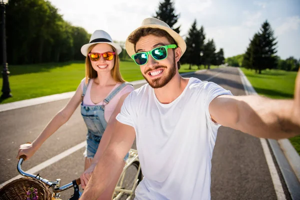 Zelfportret van vrolijke vrolijke mooie paar rijden op de fiets — Stockfoto