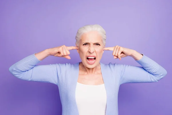 Beautiful angry gray-haired old lady wearing casual, closing her