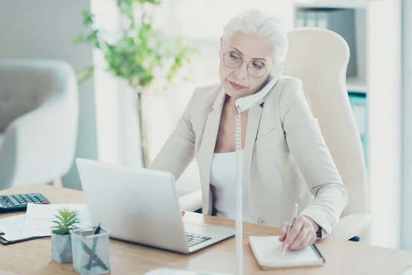 Grey-haired beautiful stylish old serious lady executive worker
