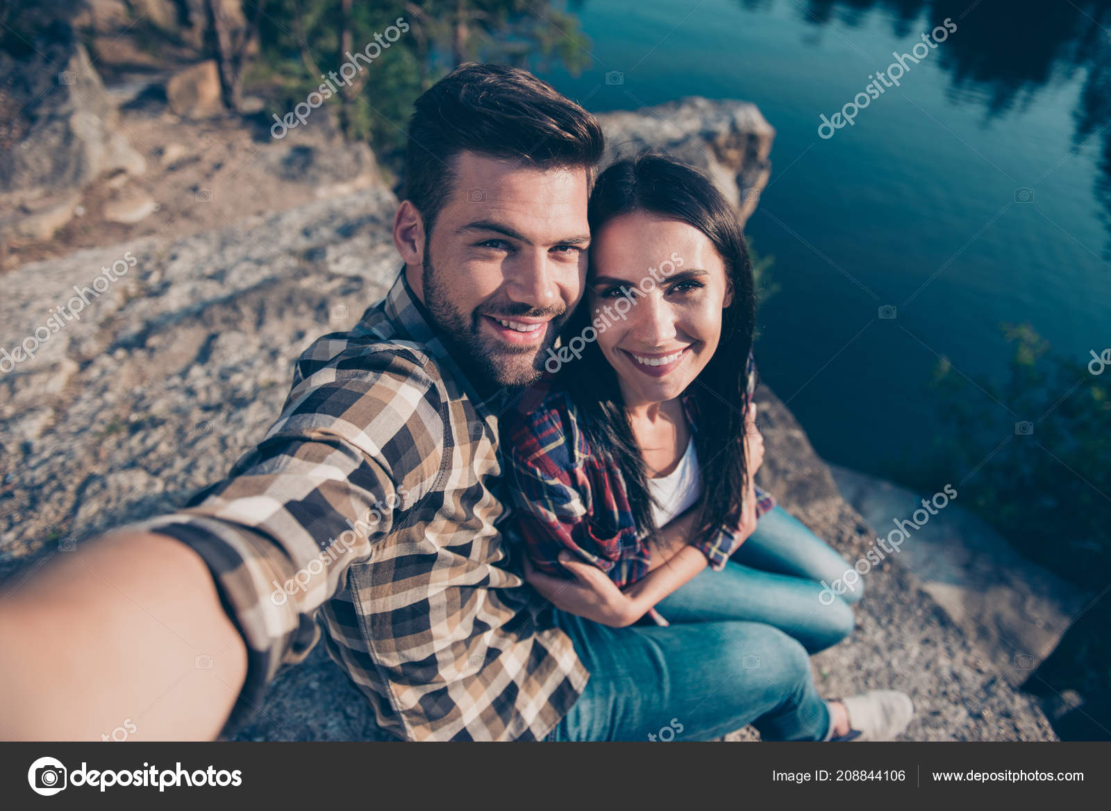 Image of a happy young beautiful loving couple posing walking outdoors in  park nature take selfie by mobile phone kissing Stock Photo - Alamy