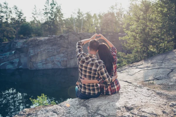 Rear back view of two people in love, wearing casual, sitting on — Stock Photo, Image
