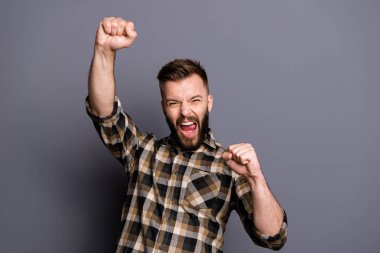 Close up portrait of young man raised his fists rejoicing at the clipart