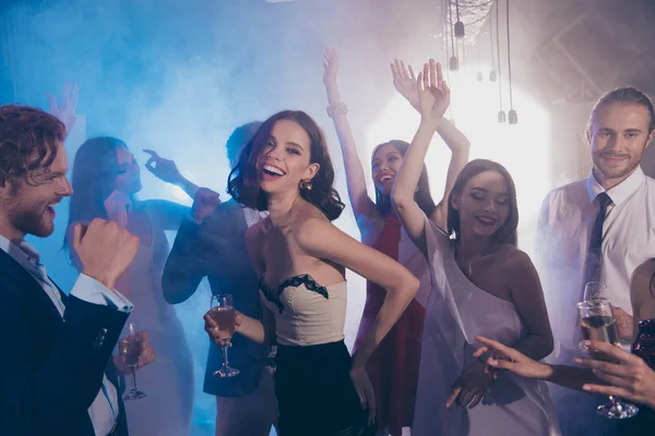 Happy lady against dancing persons with alcohol in her hand hold — Stock Photo, Image