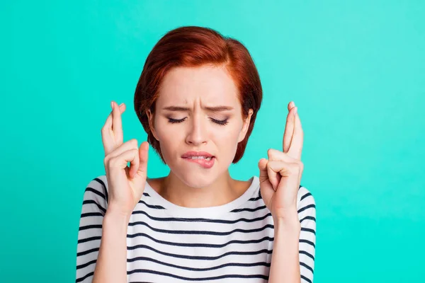 Close-up portrait of nice lovely attractive worried red-haired lady wearing striped pullover keeping crossed fingers before job interview isolated over bright vivid shine green turquoise background
