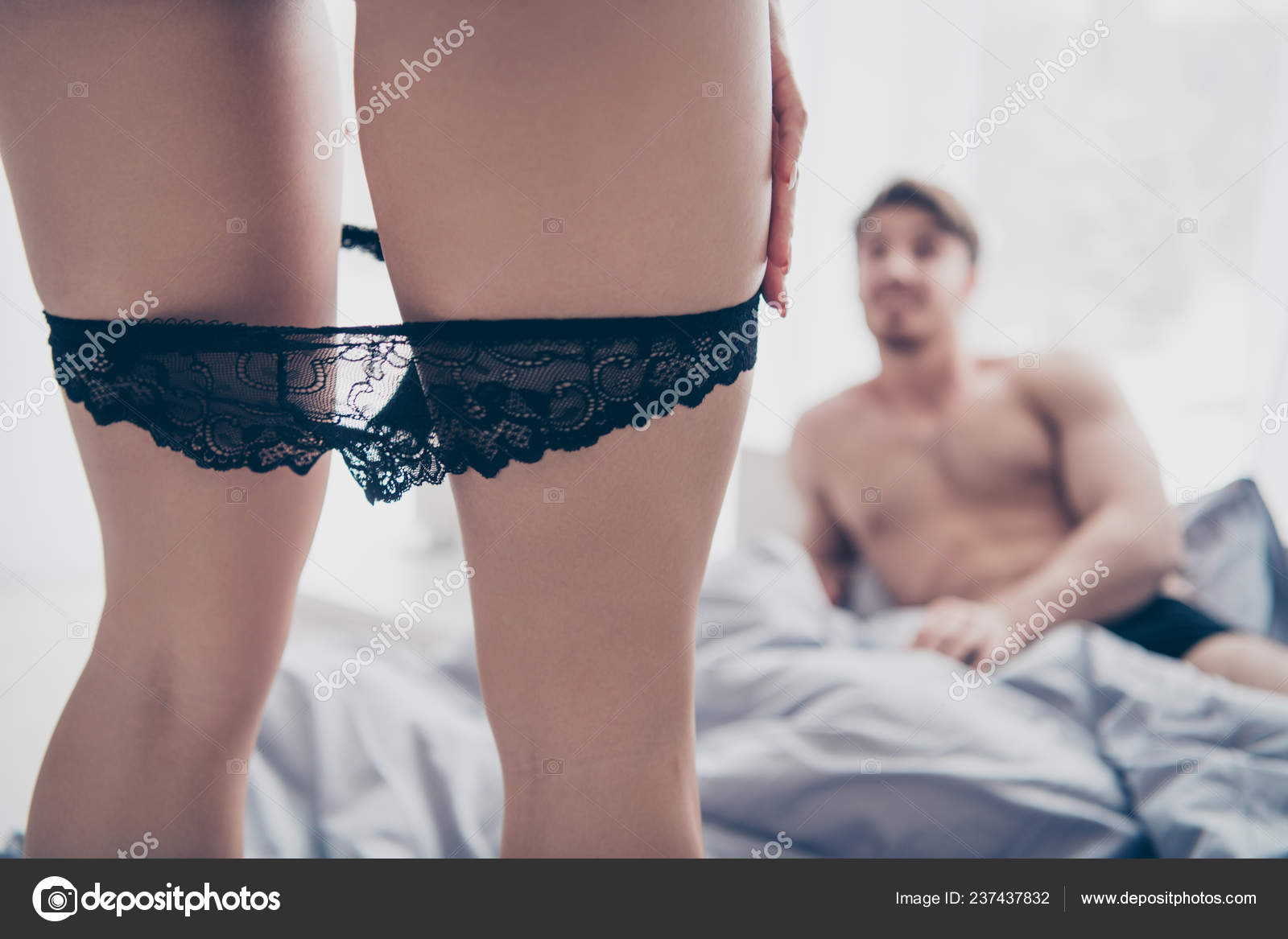 Close-up view of put off panties legs in front of attractive han Stock  Photo by ©deagreez1 237437832