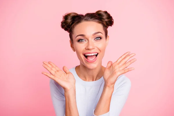 Close up photo of amazing attractive pretty she her lady with cute buns both hands pales up raised laugh laughter glad about prices wearing white pullover isolated on bright rose background — Stock Photo, Image