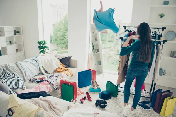 Rear back behind view of nice-looking lovely attractive pretty charming girl lady throwing things preparing for event in light white interior room — Stock Photo, Image