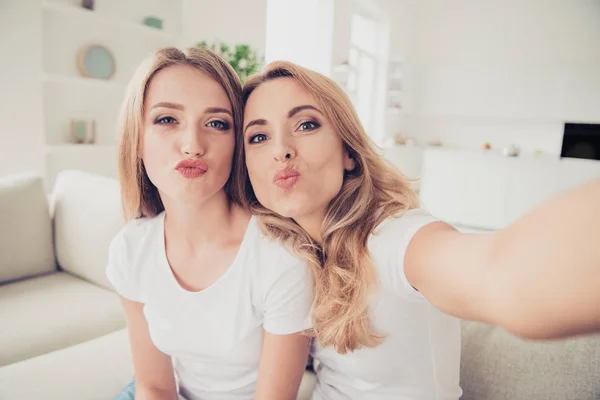De cerca la foto de dos personas bastante mamá y la hija adolescente video llamada millennials de moda hacer tomar selfies labios de pato engañar usar camisetas blancas jeans sentarse en cómodo sofá sofá — Foto de Stock
