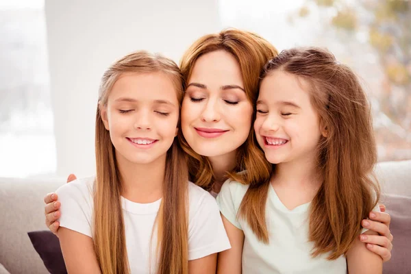 Close-up portrait of nice-looking cute lovely winsome sweet gentle tender attractive charming cheerful cheery positive blonde people mom hugging bonding pre-teen girls in house indoors — Stock Photo, Image