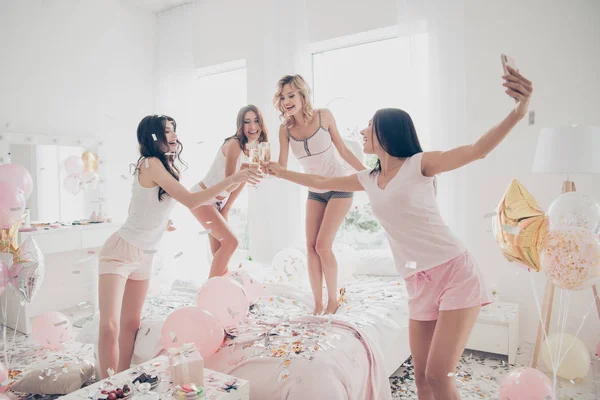 Nice-looking cool shine adorable attractive feminine charming fit thin slim graceful cheerful girlfriends having fun making selfie in light white interior decorated house — Stock Photo, Image