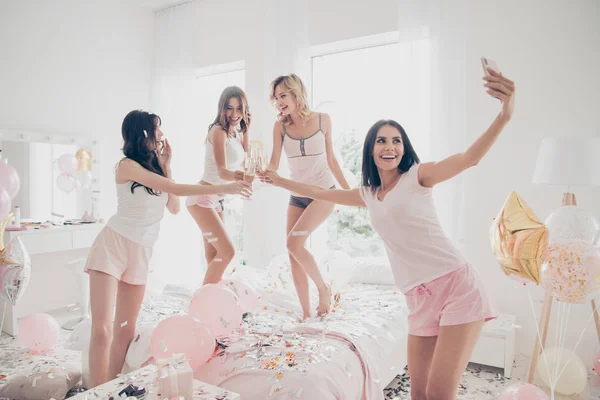 Nice sweet lovely fascinating cool attractive feminine charming fit thin slim graceful cheerful cheery girlfriends having fun making taking selfie in light white interior decorated house — Stock Photo, Image